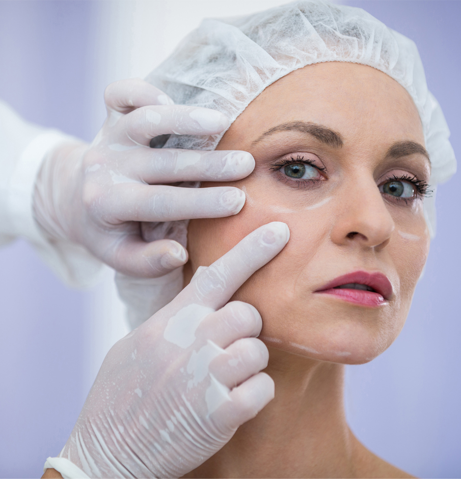 Close-up of doctor examining female patients face for cosmetic treatment